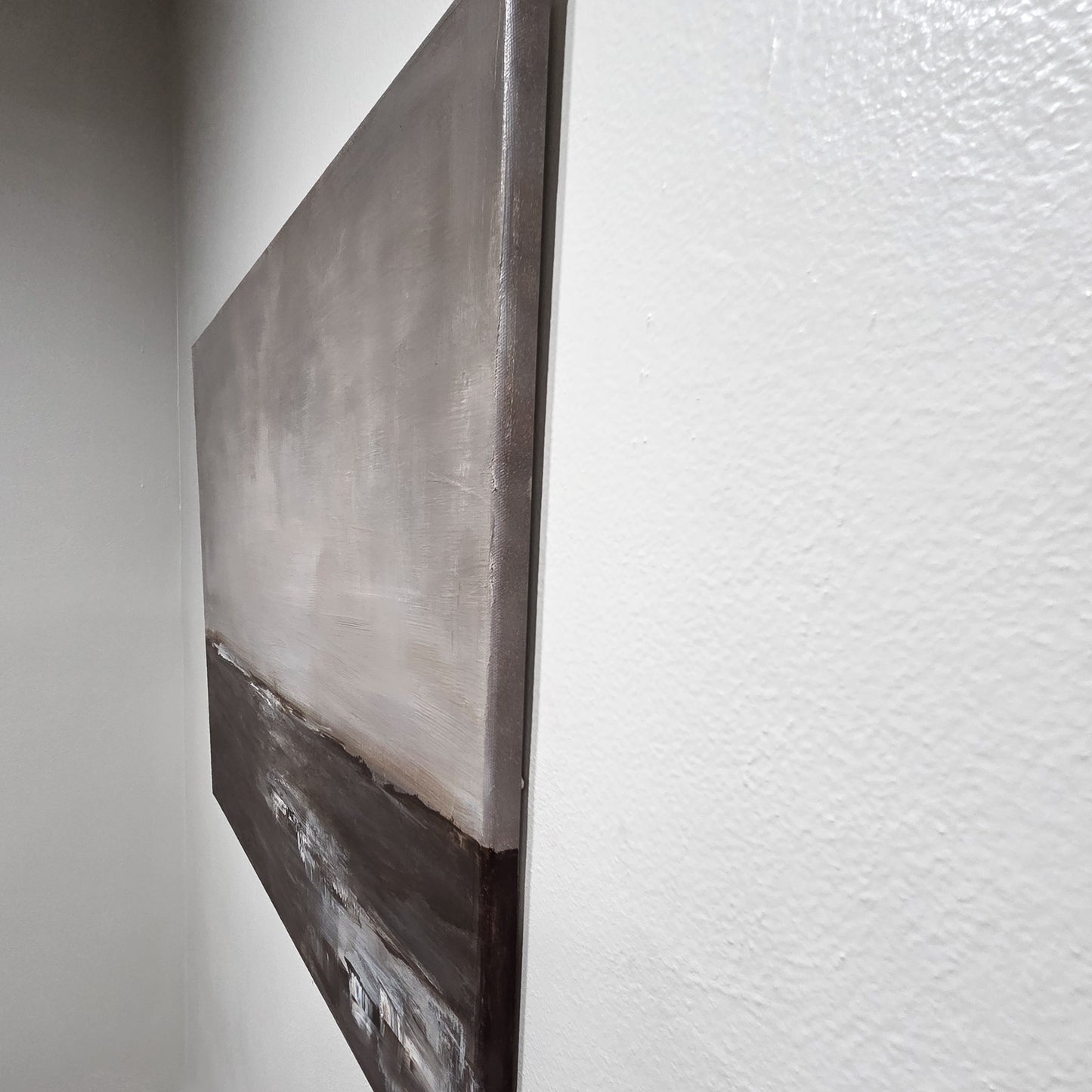 Abstract painting on a textured wall showing the painted edges.