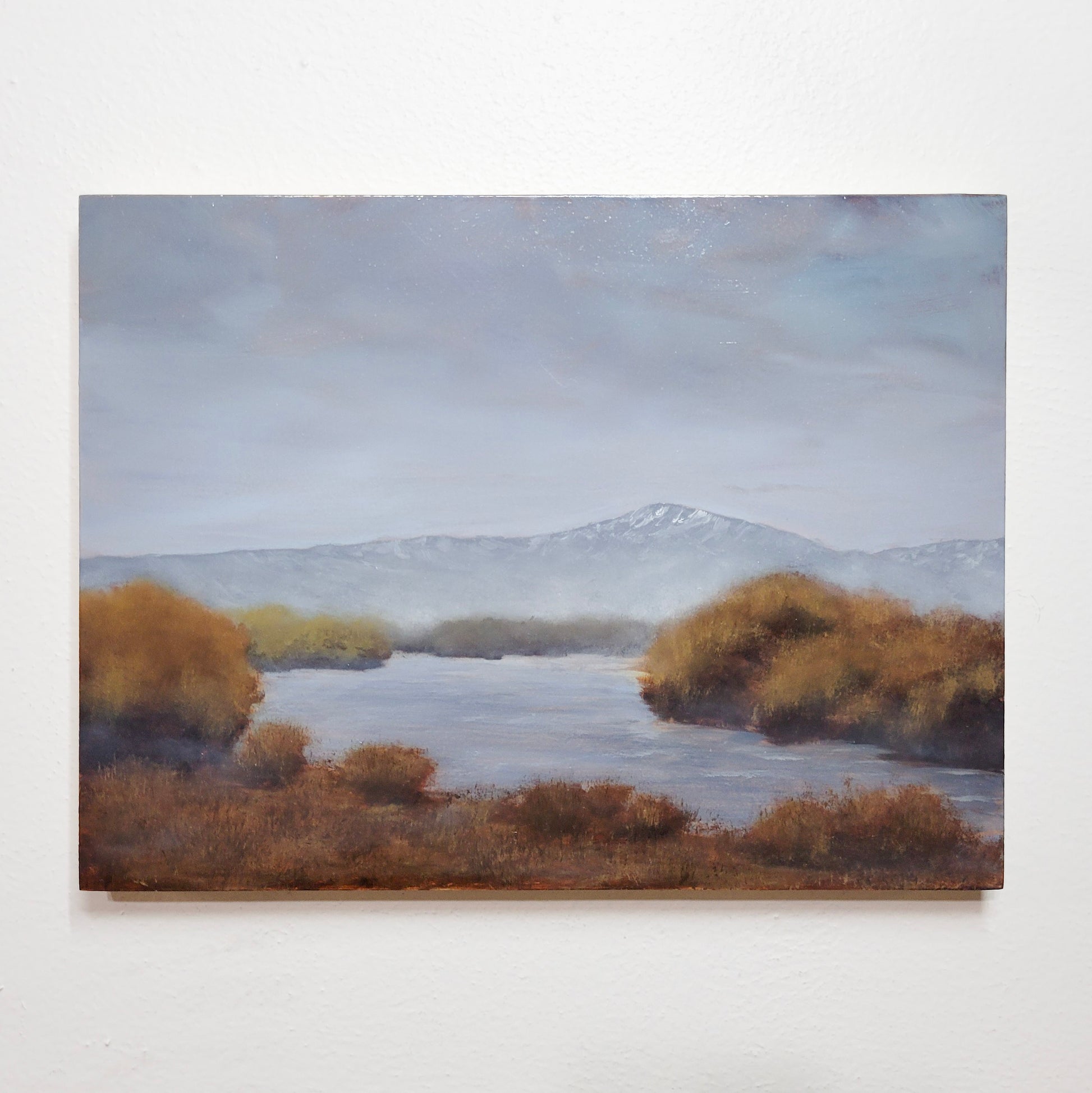 Original oil painting titled 'Mountain Haze' depicting a hazy mountain and river scene, presented on a white background.