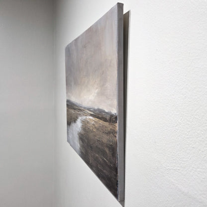 Landscape painting on a textured white wall.